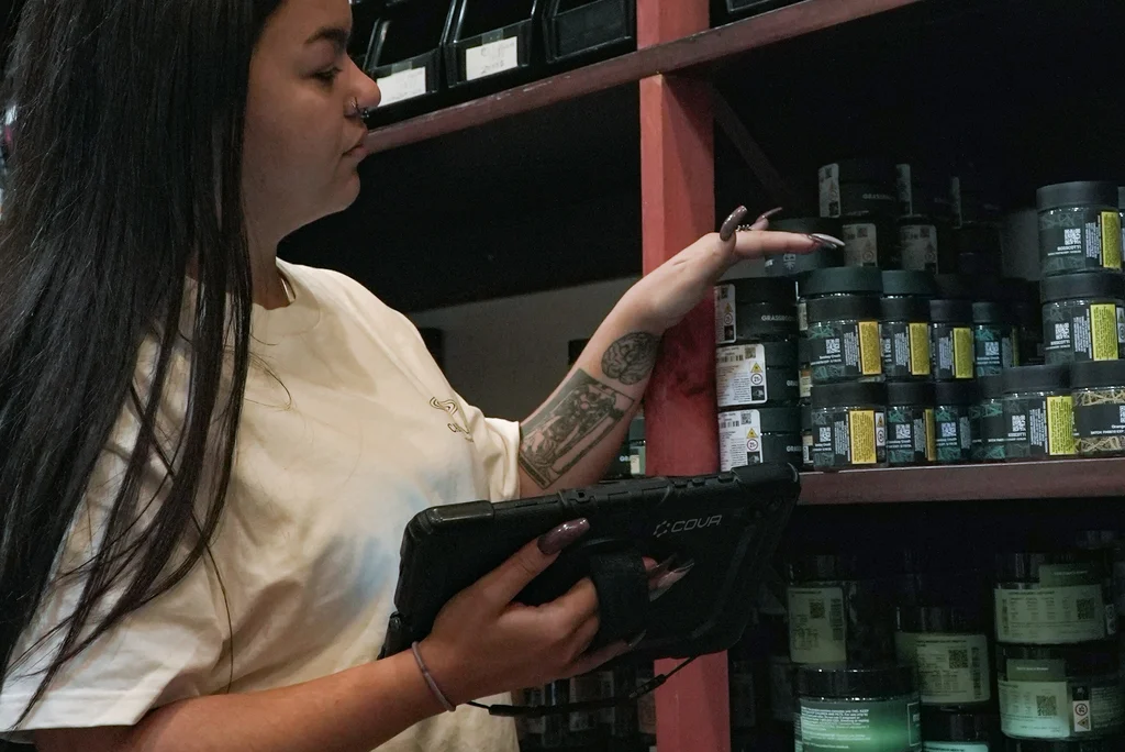 Retail worker checking inventory with a tablet
