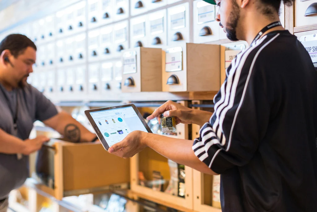 Retail staff reviewing POS data on a tablet in a store