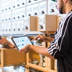 Retail staff reviewing POS data on a tablet in a store